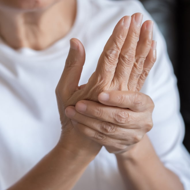 Elderly woman suffering from arthritis