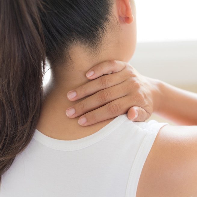 Woman suffering from neck or shoulder pain