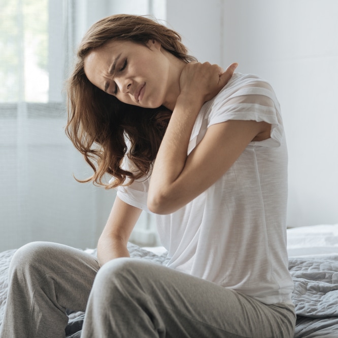 Woman suffering from neck or shoulder pain