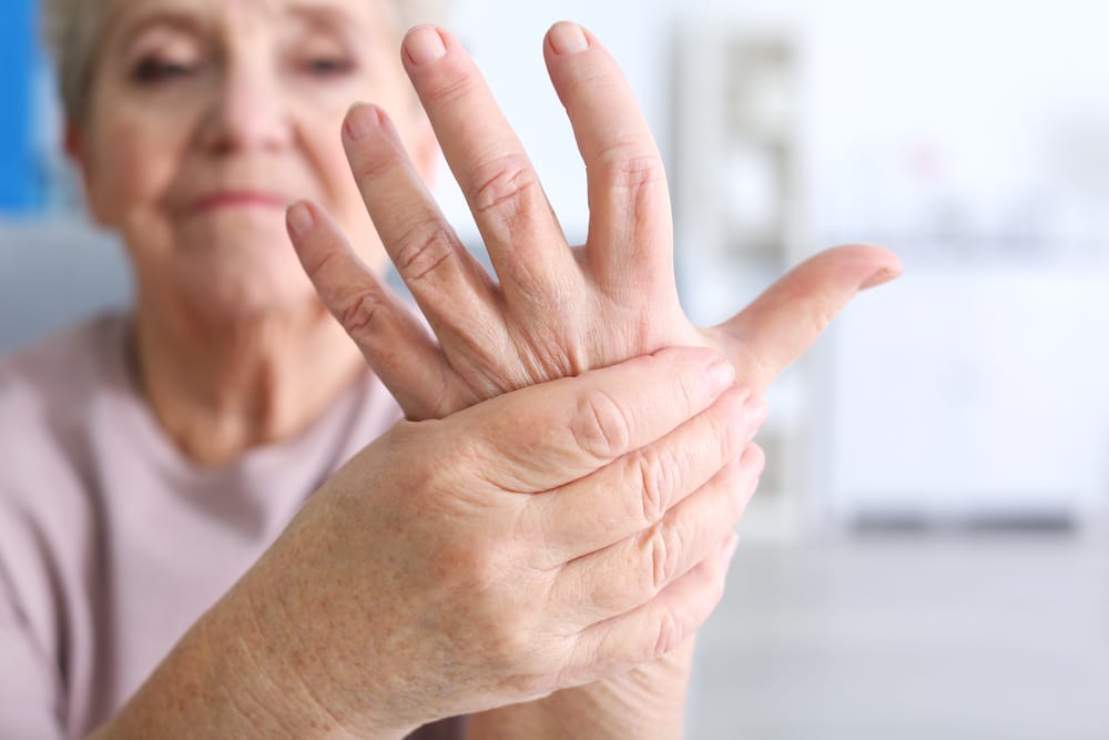 Elderly woman suffering from arthritis