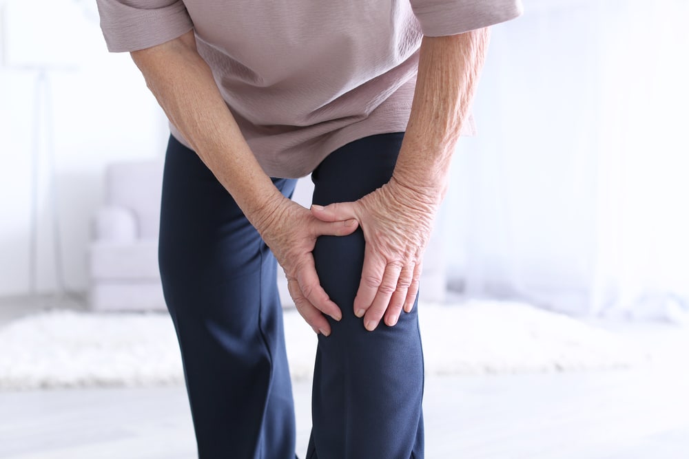 Elderly woman suffering from arthritis in knee